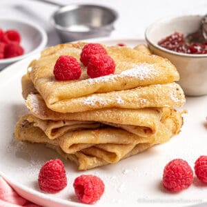 stack of folded crepes with berries
