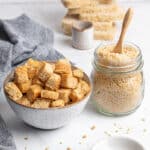 a bowl with gluten free croutons and a jar with breadcrumbs