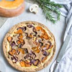 Gluten free vegan rustic tart topped with dairy free filling and vegetables