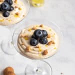 two martini cups with limoncello cream and berries.