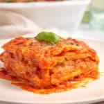 slice of homemade gluten free lasagna with tomato sauce and bechamel