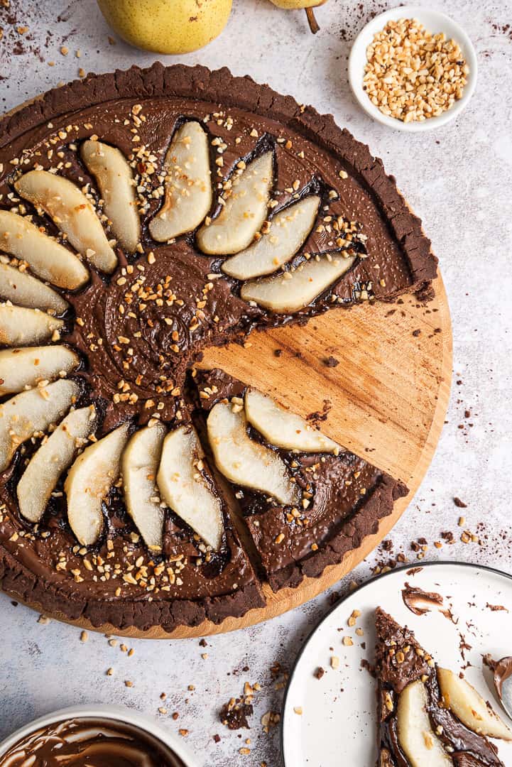 sliced vegan chocolate tart with pears