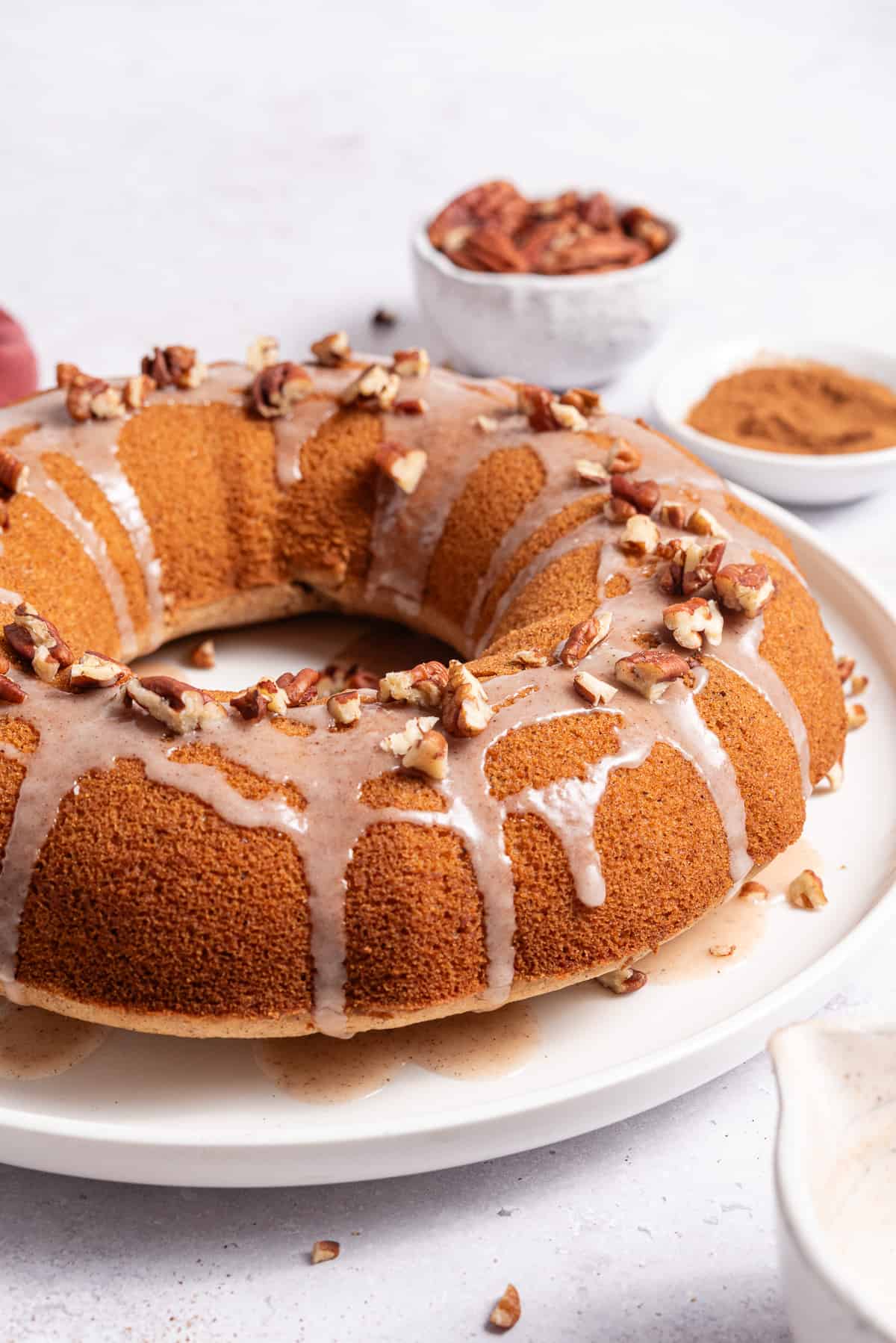 gluten free gingerbread bundt cake with glaze and pecans