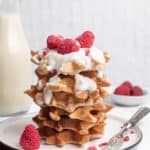 stack of homemade gluten free waffles with yogurt and raspberries