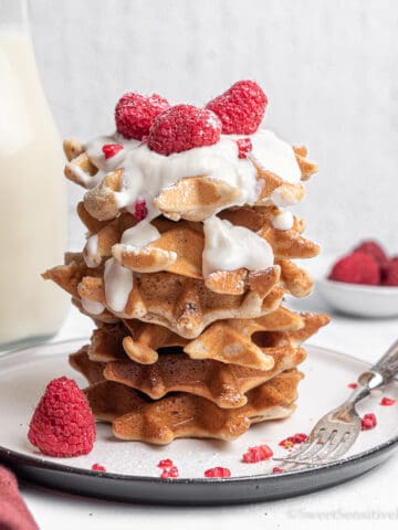 stack of waffles with berries and milk