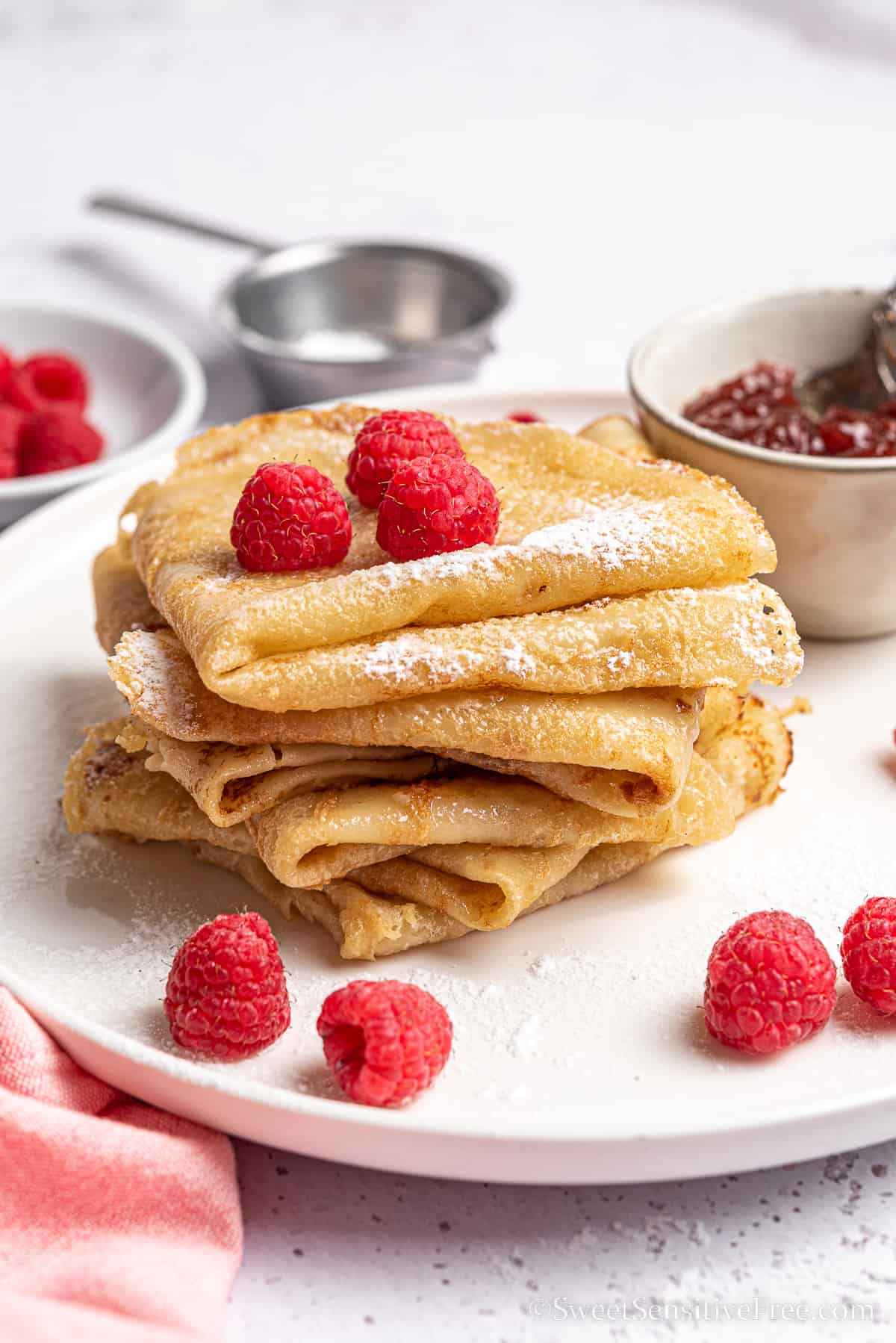 stack of gluten free vegan crepes with raspberries