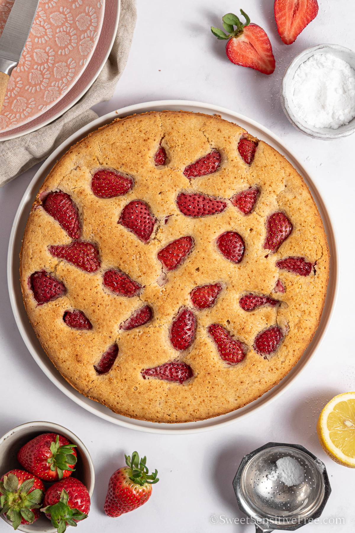 vegan strawberry cake on a plate with ingredients