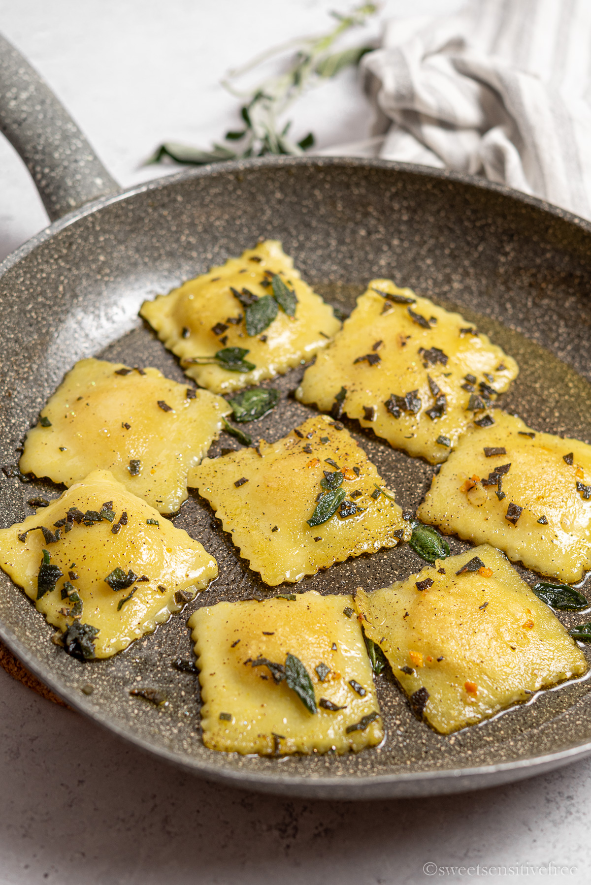 gluten free ravioli with butter and sage in a pan